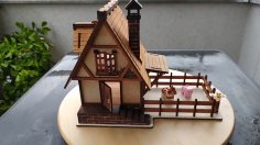 Casa de pueblo de juguete cortada con láser