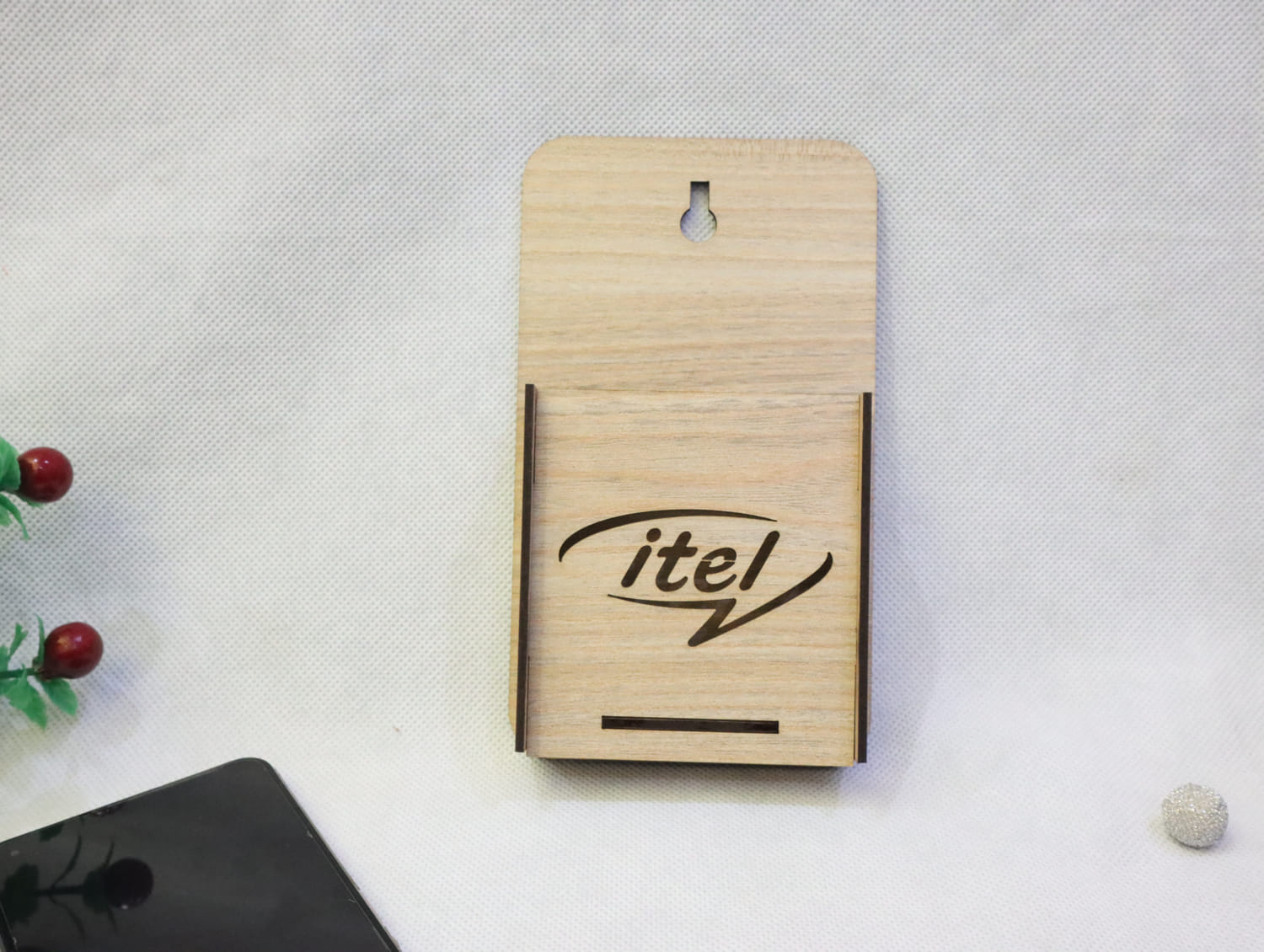 Laser Cut Wall Mounted Mobile Holder With Itel Logo Free Vector